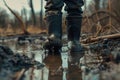 Child Feet in Dirty Puddle Close-Up, Small Rubber Boots in Mud, Mud Boosts Kids Immune System