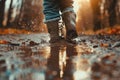 Child Feet in Dirty Puddle Close-Up, Small Rubber Boots in Mud, Mud Boosts Kids Immune System