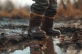 Child Feet in Dirty Puddle Close-Up, Small Rubber Boots in Mud, Mud Boosts Kids Immune System
