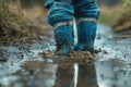 Child Feet in Dirty Puddle Close-Up, Small Rubber Boots in Mud, Mud Boosts Kids Immune System