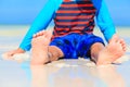 Child feet on summer beach