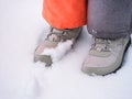 Child feet in winter shoes standing on snow Royalty Free Stock Photo
