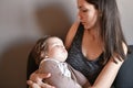 The child fell asleep in the arms of his mother. the warm embrace of the mother calmed the baby. safety in the arms of the mother Royalty Free Stock Photo