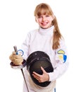 Child in fencing costume holding epee .