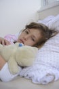 Child with fever in bed