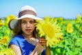 child in field of yellow flowers. teen girl in sunflower field. concept of summer vacation. rich harvest and agriculture Royalty Free Stock Photo