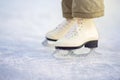 A child in figure skates stands on the ice, closeup skates Royalty Free Stock Photo