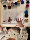 Child finger painting with colored paint on white paper. Finger painting. Concept of child development Royalty Free Stock Photo