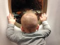 Child in front of plane window - First flight excitement