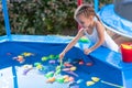 Child Fisher Catching Plastic Toy Fish On Pool Amusement Park Summer Day Royalty Free Stock Photo