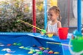 Child Fisher Catching Plastic Toy Fish On Pool Amusement Park Summer Day Royalty Free Stock Photo