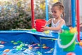 Child Fisher Catching Plastic Toy Fish On Pool Amusement Park Summer Day Royalty Free Stock Photo