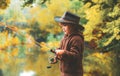 Child fishing at autumn lake. Kid with fishingrod. Royalty Free Stock Photo