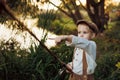 Child fishing at autumn lake