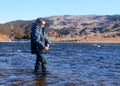 Child fishing - fly fishing in a large river Royalty Free Stock Photo