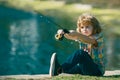 Child fishing at river or lake. Young kid fisher. Summer outdoor leisure activity. Little boy angling at river with rod. Royalty Free Stock Photo