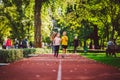 Child fitness, twins kids running on stadium track in city park , training and children sport healthy lifestyle. Outdoor Royalty Free Stock Photo