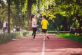 Child fitness, twins kids running on stadium track in city park , training and children sport healthy lifestyle. Outdoor Royalty Free Stock Photo