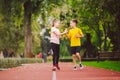 Child fitness, twins kids running on stadium track in city park , training and children sport healthy lifestyle. Outdoor Royalty Free Stock Photo