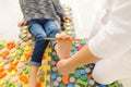 Child flatfoot treatment using special massage carpet.Little girl on massage mat doing exercises for flatfoot prevention