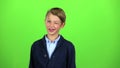 Child flirts and winks. Green screen. Slow motion