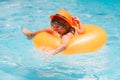 Child floating in pool. Child relaxing in pool, drink summer cocktail. Kids summer vacation. Children floating in water