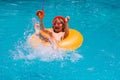 Child floating in pool. Child relaxing in pool, drink summer cocktail. Cute little boy in pool on summer day with Royalty Free Stock Photo