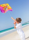 Child flying kite beach outdoor. Royalty Free Stock Photo