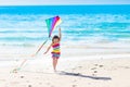 Child flying kite on tropical beach Royalty Free Stock Photo