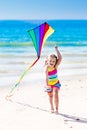 Child flying kite on tropical beach Royalty Free Stock Photo