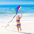 Child flying kite on tropical beach Royalty Free Stock Photo