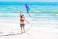 Child flying kite on tropical beach Royalty Free Stock Photo