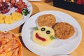 Child food. Funny food. Plate with cutlets and mashed potatoes in the form of a monkey faces. Children`s menu. Royalty Free Stock Photo