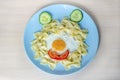 Child food. Funny food. Plate with pasta with fried egg and vegetables in the form of funny face. Children`s menu and lunch Royalty Free Stock Photo