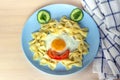 Child food. Funny food. Plate with pasta with fried egg and vegetables in the form of funny face. Children`s menu and lunch Royalty Free Stock Photo