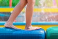 Child foot  walking on obstacle rubber bridge in summer water park Royalty Free Stock Photo