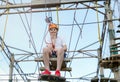 Child in forest adventure park. Kid in orange helmet and white t shirt climbs on high rope trail. Agility skills and climbing Royalty Free Stock Photo