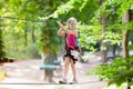 Child in adventure park. Kids climbing rope trail. Royalty Free Stock Photo