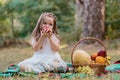 Child on forest picnic eating apple. Toddler kid in sunny park or garden. Little girl enjoying leisure. Royalty Free Stock Photo