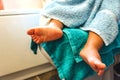 Child fresh from bath with towel and foot wrinkled by water