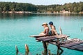 child friends on the pier at sunset on beautiful lake. Boy and girl. Kid looking around. clean blue water. Alone kids on Royalty Free Stock Photo