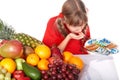 Child with fruit and vitamin pill. Royalty Free Stock Photo