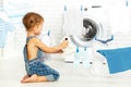 Child fun happy little girl to wash clothes and teddy bear in l Royalty Free Stock Photo