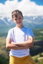 A child funny boy on the Altai mountain background.