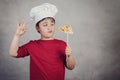 Child funny cook with slice pizza