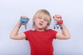 Child with funny face holding two toy shopping cart. Purchases for children. Baby shopping Royalty Free Stock Photo