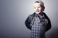 Child. Funny Little Boy in Jeans. Trucker cap. joy. Fashionable Kid. plaid shirt. Denim Wear Royalty Free Stock Photo