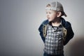 Child. Funny Little Boy in Jeans. Trucker cap. joy. Fashionable Kid. plaid shirt. Denim Wear