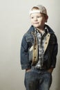 Child. Funny Little Boy in Jeans. Trucker cap. joy. Fashionable Kid. plaid shirt. Denim Wear Royalty Free Stock Photo