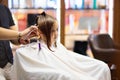 Child getting haircut. Hairdresser cutting hair Royalty Free Stock Photo